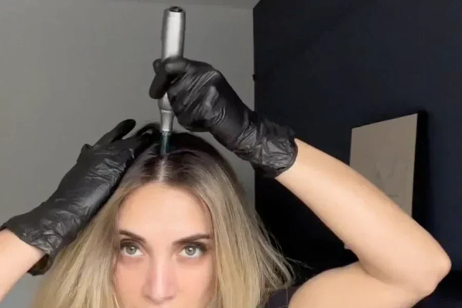 a woman using Dr. Pen M8S for microneedling on scalp