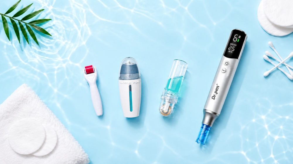 Flat lay of microneedling skincare tools, including a Dr. Pen microneedling pen, derma roller, derma stamp and serum applicator, arranged with cotton pads, cotton swabs and green leaves on a clean white and light blue background.