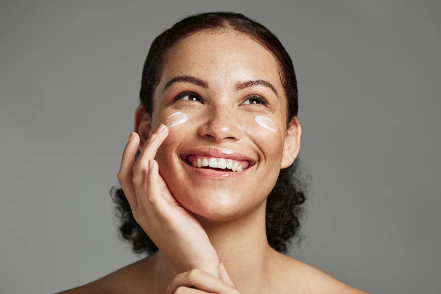 Women using skin tightening cream on her face