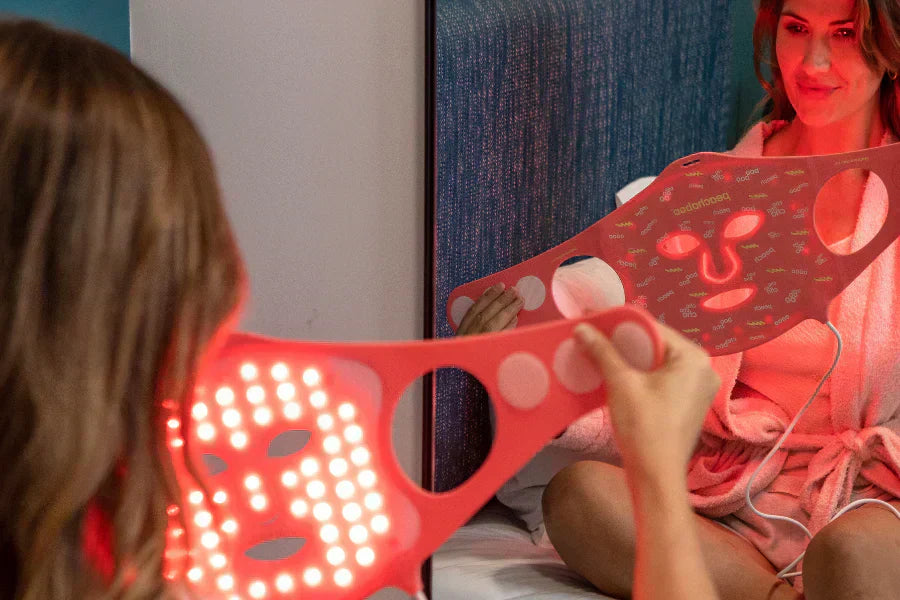 Women holding Peachaboo Pro Glo Silicone LED light therapy mask 