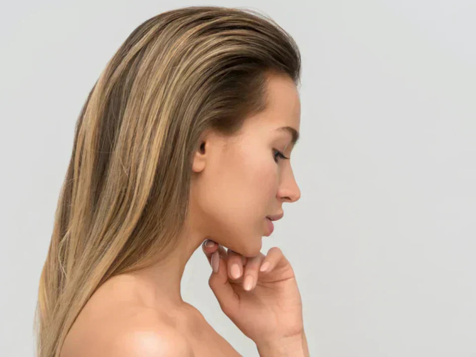 woman with flawless skin, looking downwards