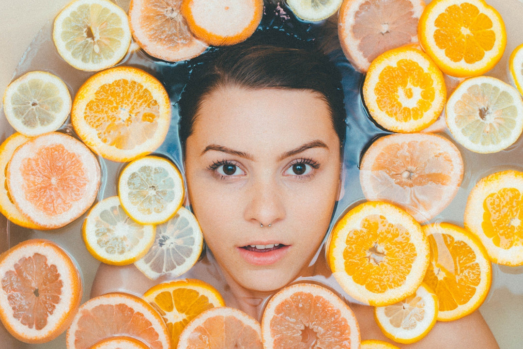 Pretty women face with slices of oranges 