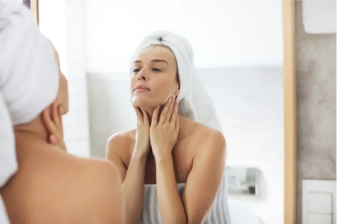 Women looking into the mirror. showing concerns on sign of aging