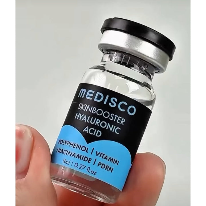 Close up to Medisco Skinbooster Hyaluronic Acid vial held in a hand 